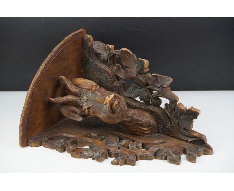Late 19th Century Victorian carved black forest corner shelf. The shelf having a carved deer bust flanked by pierced foliate 