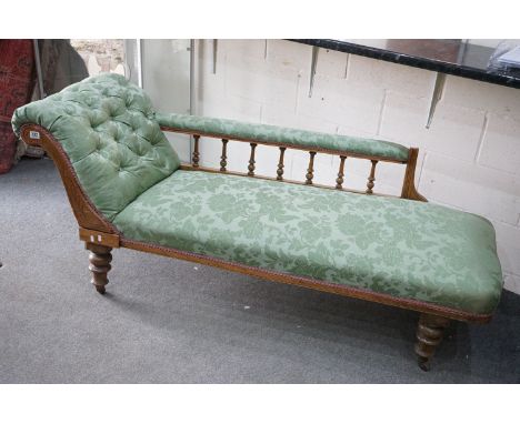 Victorian Walnut Framed Chaise-lounge with green button back upholstery, raised on turned legs with castors, 180cm long x 78c