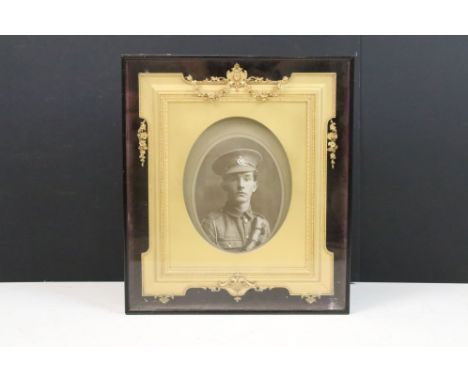 A late 19th century picture frame, the stained rosewood outer case with glazed panel enclosing an ornate giltwood and gesso f