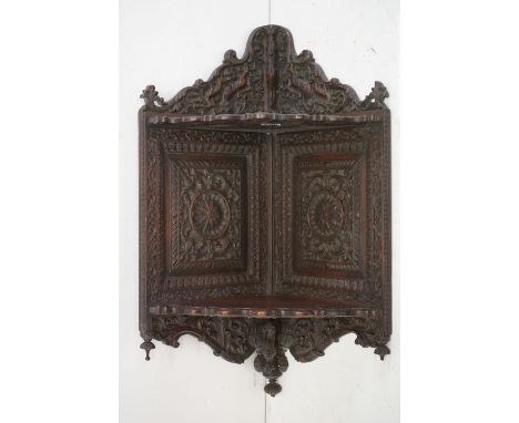 19th century Anglo Indian Hardwood Hanging Corner Shelf, profusely carved including lions, deer, a bird and scrolling foliage