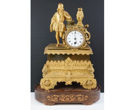 19th Century French gilt mantle clock having a gilt male figure to the top beside a white enamelled dial with roman numerals 