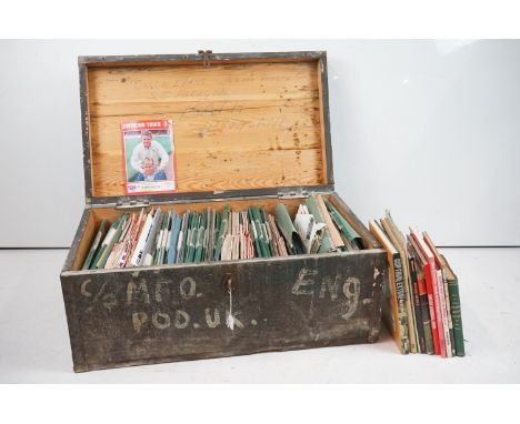 A large collection of Swindon Town football club programmes contained within a large wooden storage trunk. 