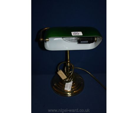 A modern Brass desk Lamp with green glass shade.