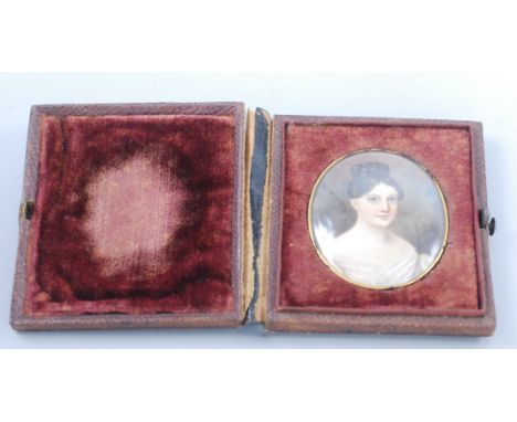 An early nineteenth century English portrait miniature of a young lady, her hair in a bun, 5cm x 4.2cm.