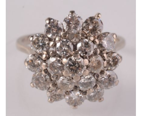 An 18ct white gold diamond peg set cluster ring. 