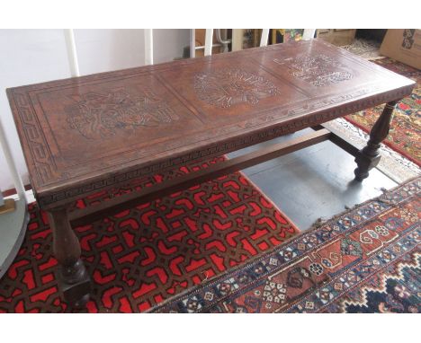 A leather covered low table, circa 1960s, the top with Inca decoration on turned wood supports joined by an 'H' stretcher, he