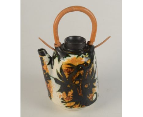 A Celtic Pottery, Newlyn teapot, height including cane handle 28cm. 