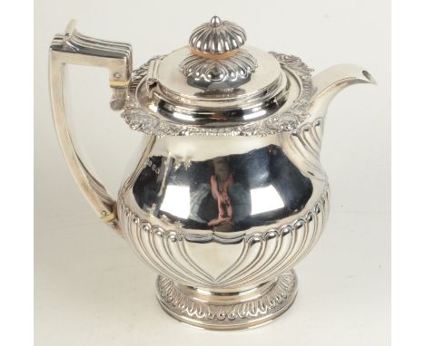 A George III silver hot water jug, the pear shape body with half fluting, the borders embossed with gadrooning and roses, the