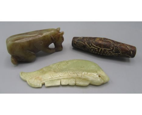 A carved jade fish, a Chinese large bead and one other stone carving. 