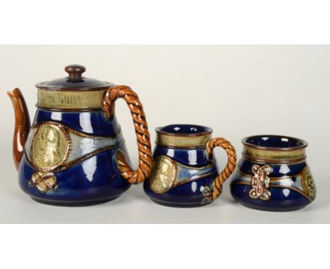 A Royal Doulton Lambeth stoneware three piece tea set, comprising a teapot, cream jug and sugar bowl, inscribed 'Lord Nelson,