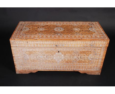 A middle eastern mother of pearl inlaid and arabesque carved chest, probably Syrian, width 84cm.