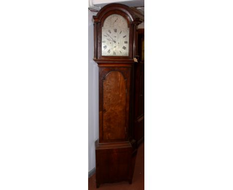 A mahogany eight day longcase clock, early 19th century, with an arched silvered dial decorated with floral sprays, flanked b