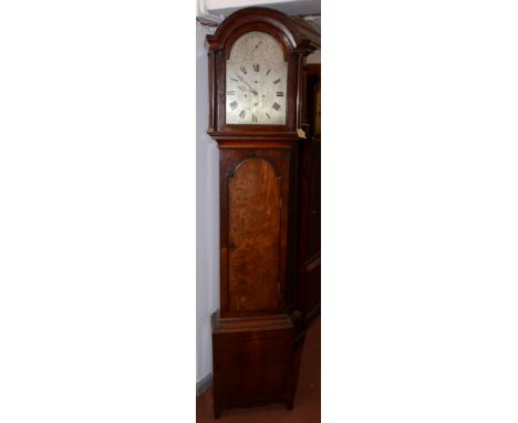 A mahogany eight day longcase clock, early 19th century, with an arched silvered dial decorated with floral sprays, flanked b