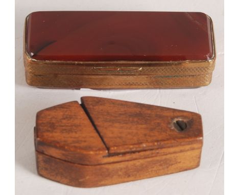 A gold plated agate snuff box, length 6.5cm and a wooden coffin shaped snuff box, length 5.5cm.   Condition report:  Crack an