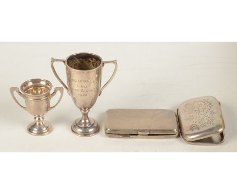 An engraved silver cigarette case, an engine turned silver cigarette case and two small silver trophy cups. 6oz. 