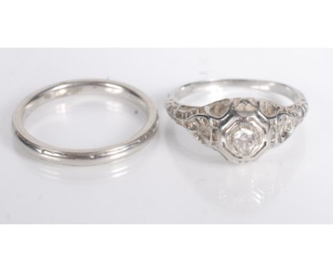 An American 18ct white gold diamond set ring with filigree shoulders, together with an 18ct white gold band. 