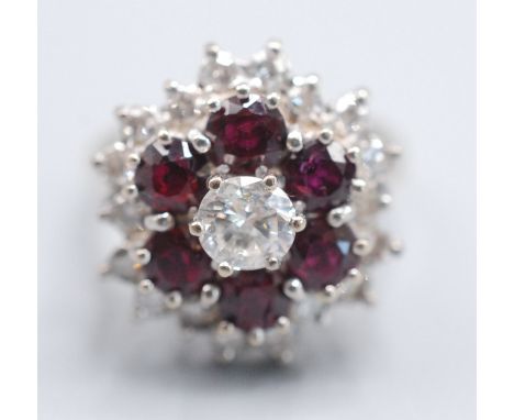 An 18ct white gold target cluster ruby and diamond ring.