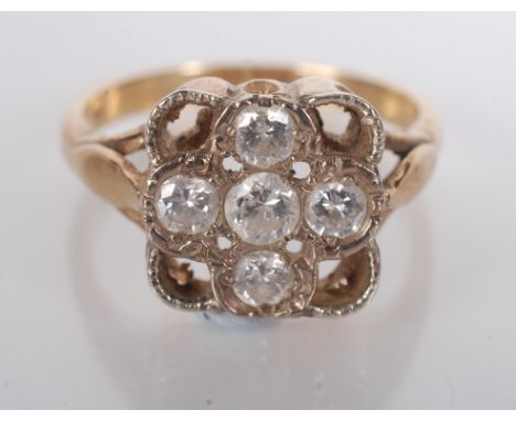 An 18ct. gold ring set with five diamonds forming a cross within a square.   Condition report:  4.2g.