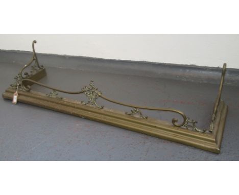 A brass fender, length 137cm, height 29.5cm and a brass fireguard, height 65cm, width 61cm.