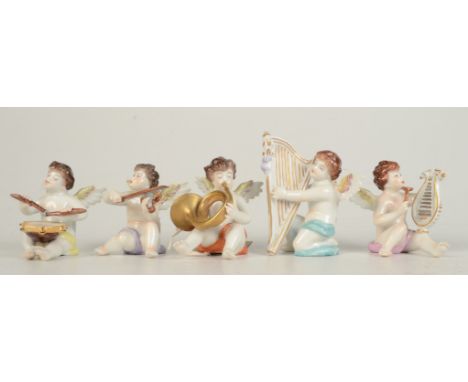 Five continental porcelain figures of winged cherubs playing musical instruments, height of largest 8.3cm.   Condition report