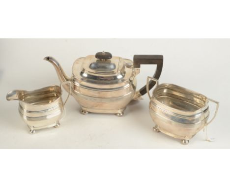 A Georgian style three piece square section reeded tea service on bun feet, 30.8oz.