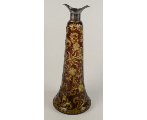 A coloured cut glass decanter, the silver mount hallmarked London 1904, the brown body with incised thistles and scrolling fo