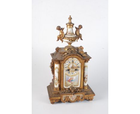 A French gilt metal mantel clock, 19th century, the urn finial flanked by seated cherubs above a painted porcelain dial and c