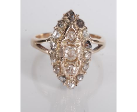 A gold ring marquise pave set with rose cut diamonds.
