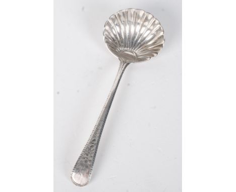A George III sauce ladle with shell bowl, the feather edge handle with floral engraving, London, by Thomas Wallis.
