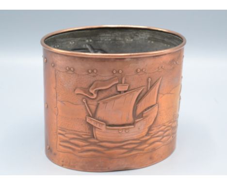 A Newlyn copper tea caddy, of oval form, repousse decorated with three sailing ships in full sail at sea, impressed mark, cov