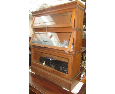 An oak Globe Wernicke style sectional bookcase, with three glazed doors and a plinth base, height 115cm, width 87cm, depth 26