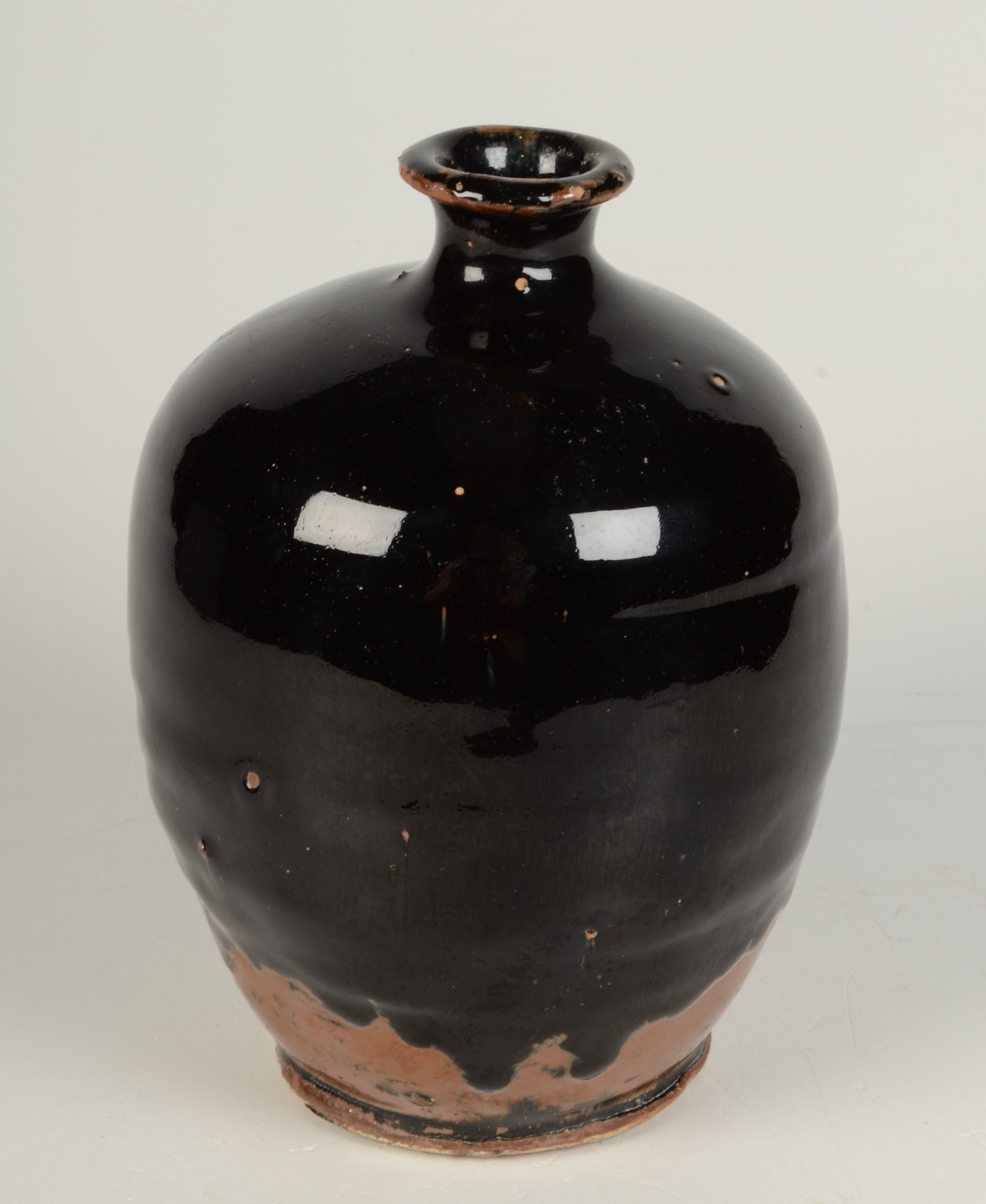 A Japanese tenmoku glaze pottery vase, height 18.5cm.