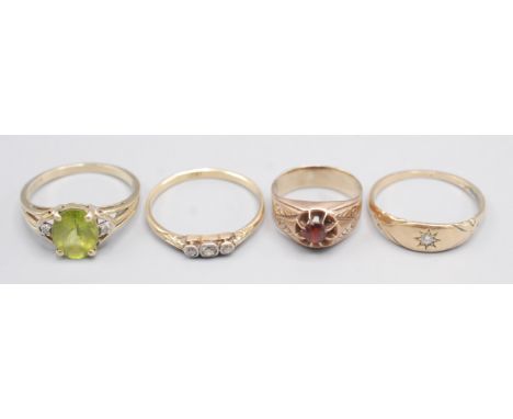 A diamond and peridot 9ct gold ring, a gold ring gypsy set a diamond, one other diamond ring and a ruby set gold ring. 