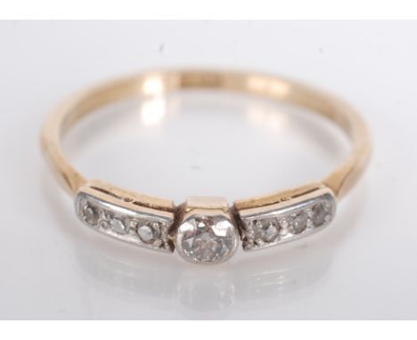 An 18ct gold ring set with a line of seven diamonds, 1920s style.   Condition report:  2.3g.