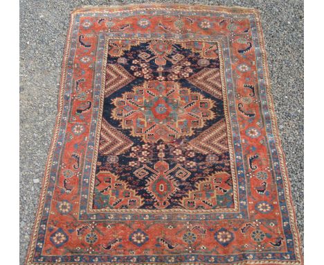 An Afshar rug, South West Persia, the indigo field with a central polychrome medallion, with a serrated leafy vine and flower
