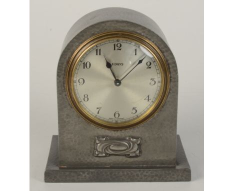 A Tudric hammered pewter mantle clock, impressed no 5050, height 16cm, width 14.2cm. 