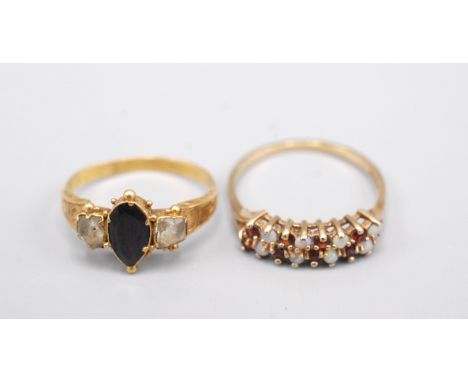 An early Victorian gold ring and a gold ring set with opals and garnets.