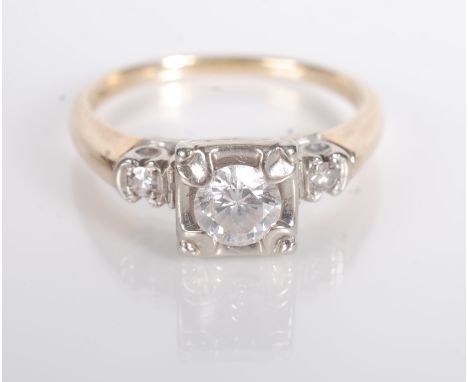 A 14ct. gold ring set with a diamond of approximately 0.33cts. spread, the shoulders set with small diamonds.