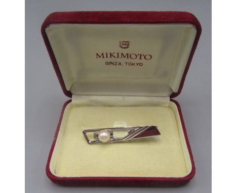 A Mikimoto pearl mounted silver tie clip impressed trademark, original box and leaflet.