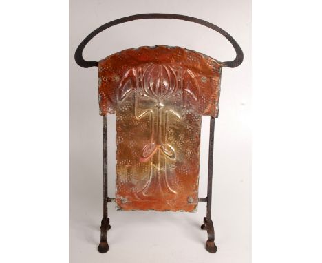 An Art Nouveau copper and iron firescreen repousse decorated with a stylised tulip, height 69cm, together with a hammered cop