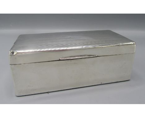 An engine turned silver cigarette box.