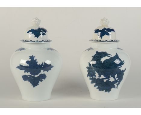 A pair of Rosenthal Bavaria blue and white porcelain vases, the covers surmounted with a basket of fruit finial, the baluster