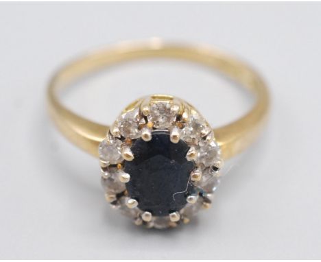 An 18ct gold sapphire and diamond cluster ring.