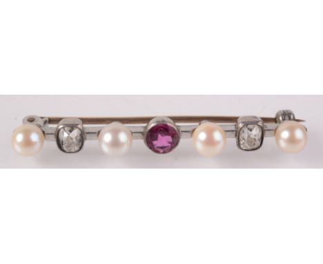 A bar brooch set two cushion cut diamonds, a central ruby and four pearls.    Condition report:  Width 5cm, Diameter 5mm x 3.