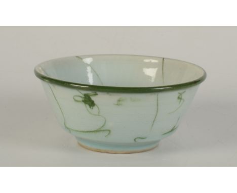 A Chinese South East Asian celadon bowl, the interior decorated with six wavy, leaf green linear lines emerging from a centra