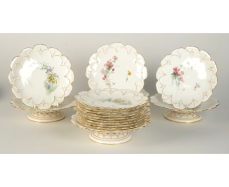 A set of twelve Royal Worcester porcelain plates and four matching comports, of Regent shape, gilt decorated and painted with
