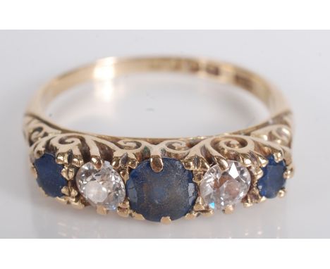 An Edwardian 18ct gold ring set with three sapphires and two diamonds.