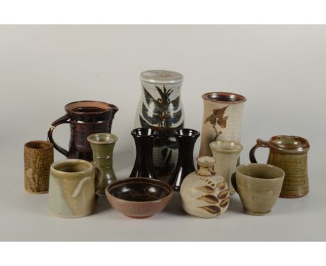 A selection of studio pottery items, including a Leach lustre decorated jug, height 16cm and a Leach mug, height 16cm. 