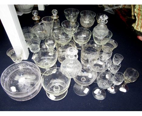 A large selection of miscellaneous glassware, including champagne glasses, a pair of decanters with silver collars and glass 