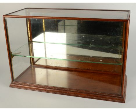 A mahogany and glazed table top shop display cabinet, early 20th century, with a solid panelled rear door and single glass sh